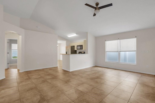 unfurnished living room featuring lofted ceiling, light tile patterned floors, and ceiling fan