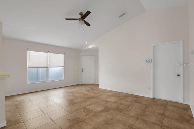 spare room featuring light tile patterned floors, high vaulted ceiling, and ceiling fan