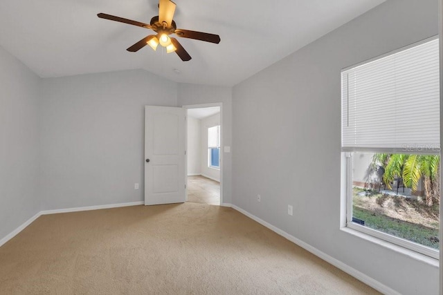 carpeted empty room featuring lofted ceiling and ceiling fan