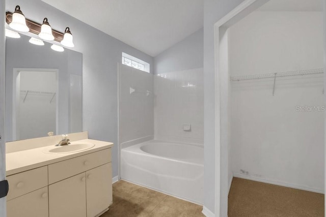 bathroom featuring lofted ceiling, tile patterned flooring, and vanity