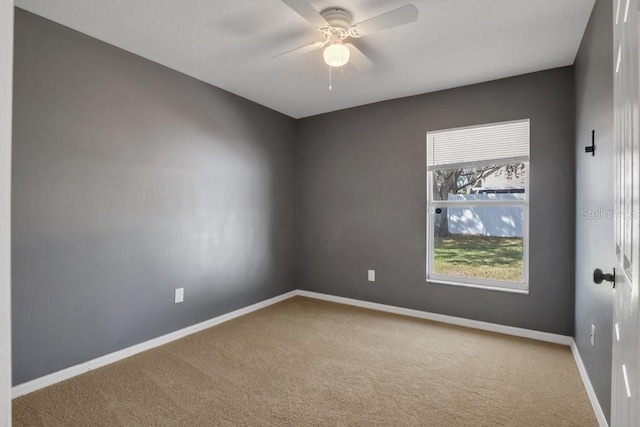 carpeted empty room with ceiling fan