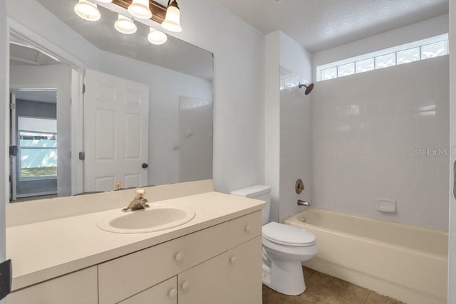 full bathroom featuring tiled shower / bath combo, vanity, tile patterned floors, and toilet