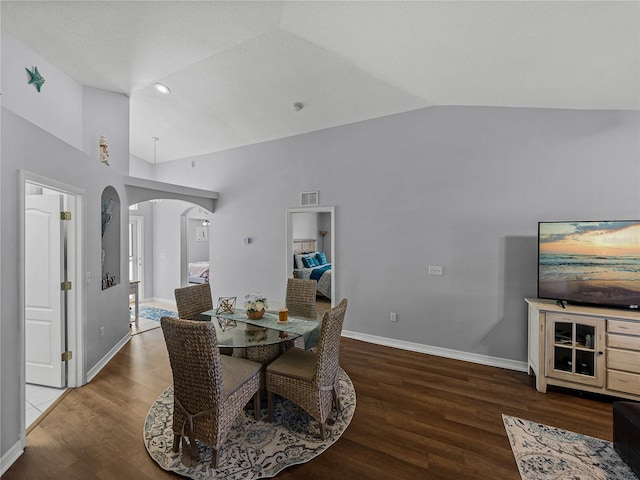 dining room featuring wood-type flooring and lofted ceiling