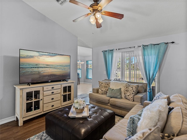 living room with lofted ceiling, ceiling fan, and dark hardwood / wood-style floors