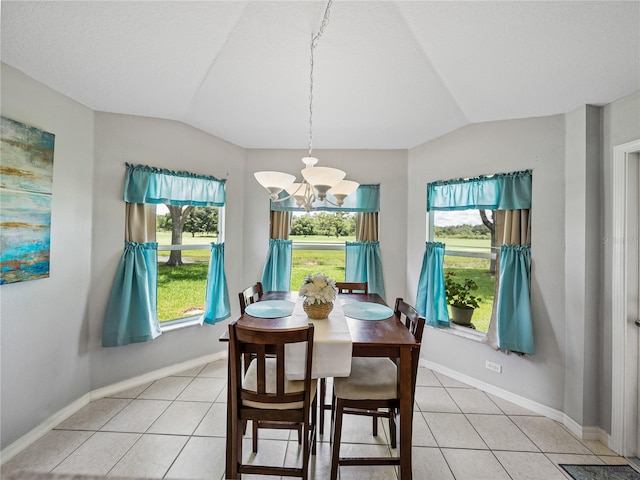 tiled dining area featuring vaulted ceiling and a notable chandelier