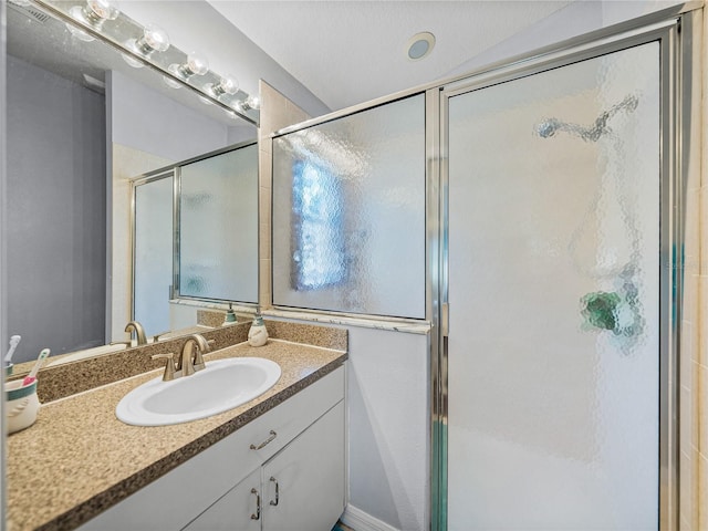 bathroom with an enclosed shower and vanity