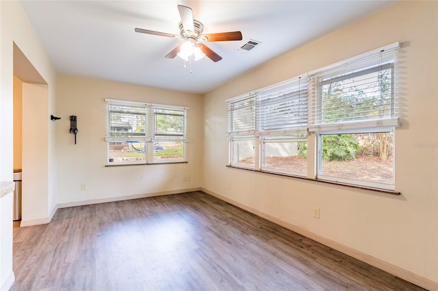 spare room with ceiling fan and light hardwood / wood-style floors