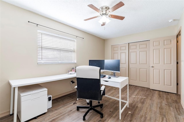 office space with ceiling fan, light hardwood / wood-style floors, and a textured ceiling