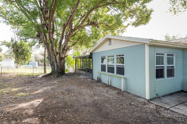 view of property exterior featuring a sunroom