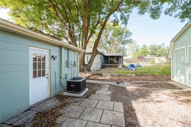 view of patio featuring an outbuilding and cooling unit