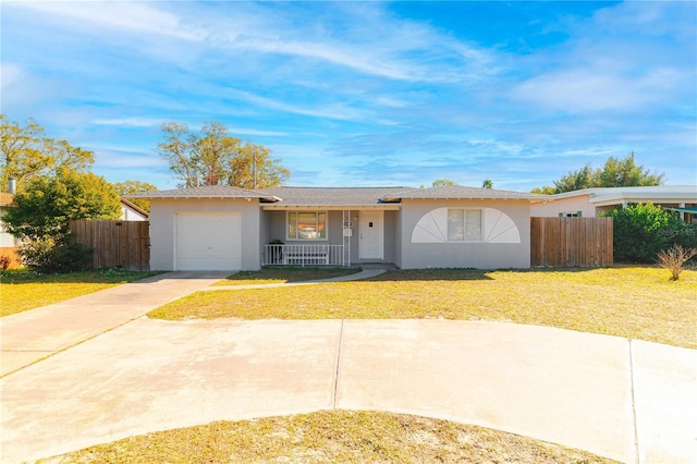 ranch-style house featuring a garage, a front lawn, and covered porch