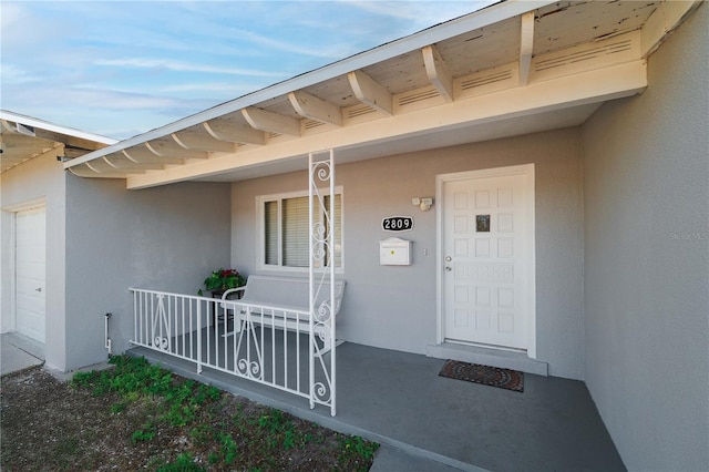 view of exterior entry featuring a porch