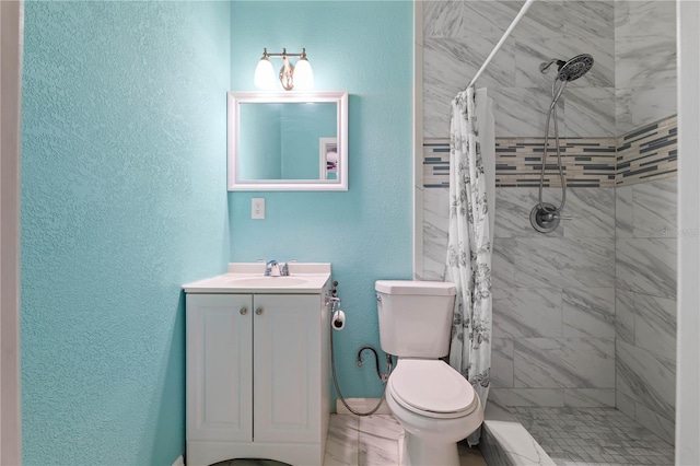 bathroom featuring vanity, toilet, and walk in shower