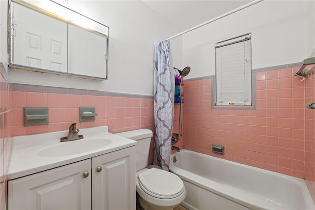 full bathroom with vanity, toilet, shower / bath combo with shower curtain, and tile walls