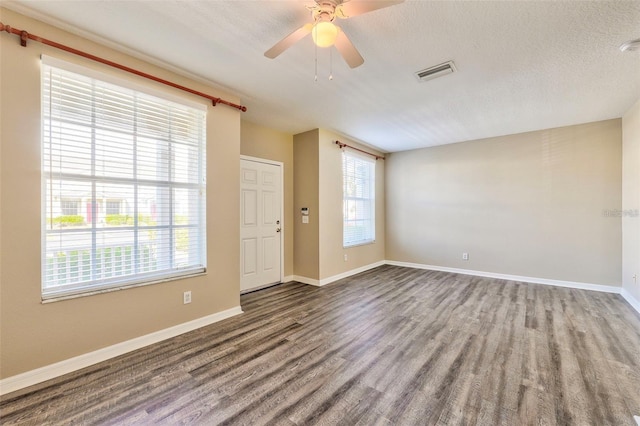 spare room with ceiling fan, wood-type flooring, and a textured ceiling