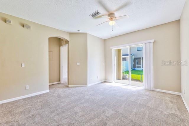 carpeted spare room with ceiling fan and a textured ceiling