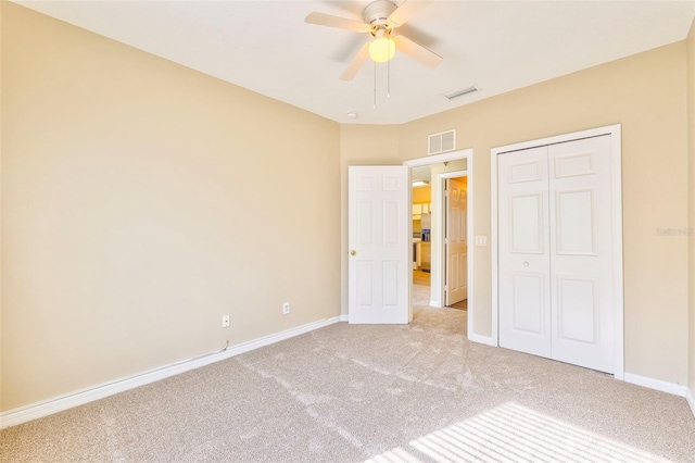 unfurnished bedroom featuring ceiling fan, carpet flooring, and a closet