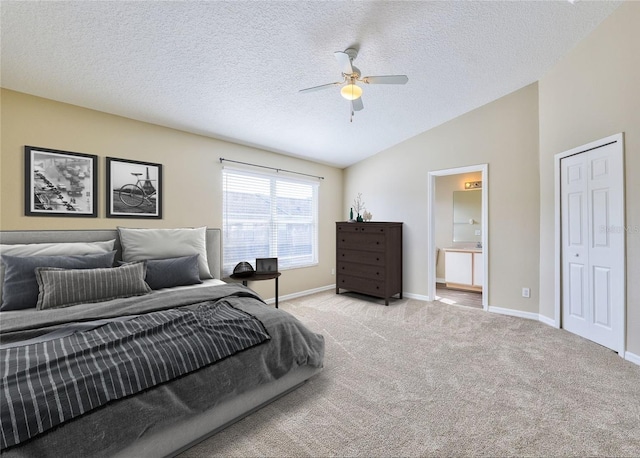 bedroom with ceiling fan, light colored carpet, lofted ceiling, and a textured ceiling