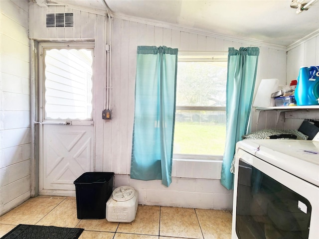 bathroom featuring plenty of natural light, washer / dryer, and tile patterned flooring