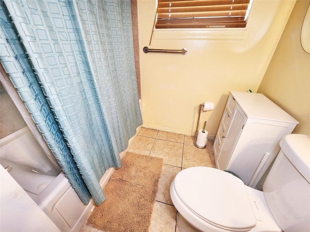 bathroom featuring shower / tub combo with curtain, toilet, and tile patterned flooring