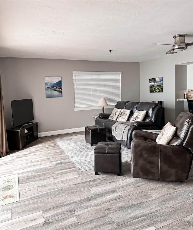 living room featuring light hardwood / wood-style flooring and a textured ceiling