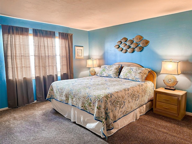 bedroom featuring dark colored carpet