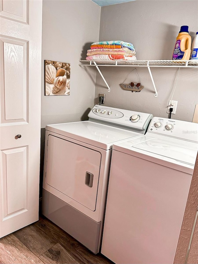 clothes washing area featuring independent washer and dryer and dark hardwood / wood-style floors