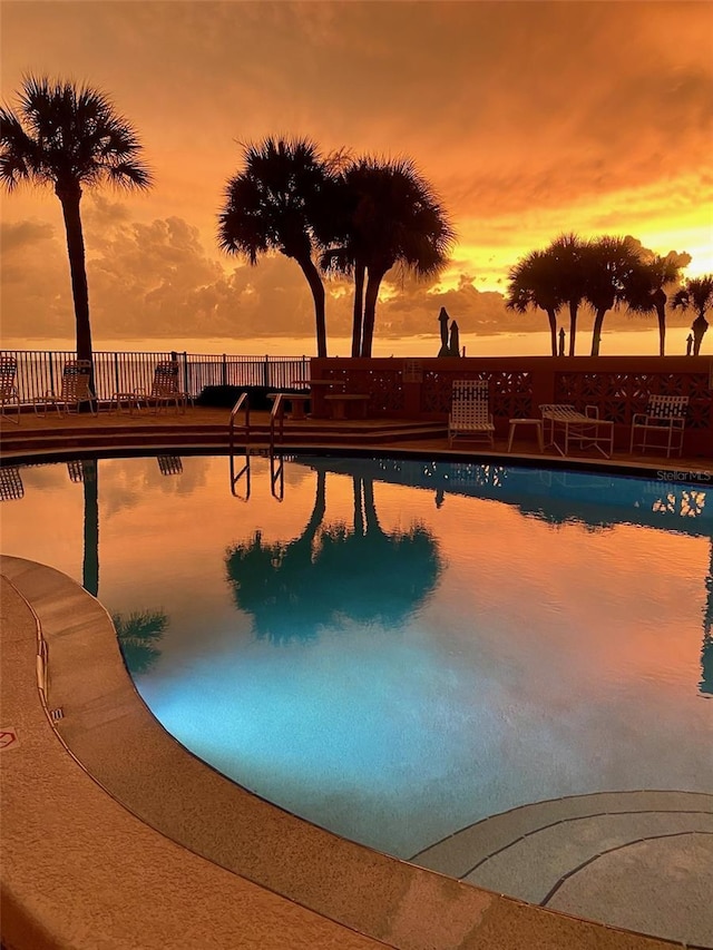 view of pool at dusk