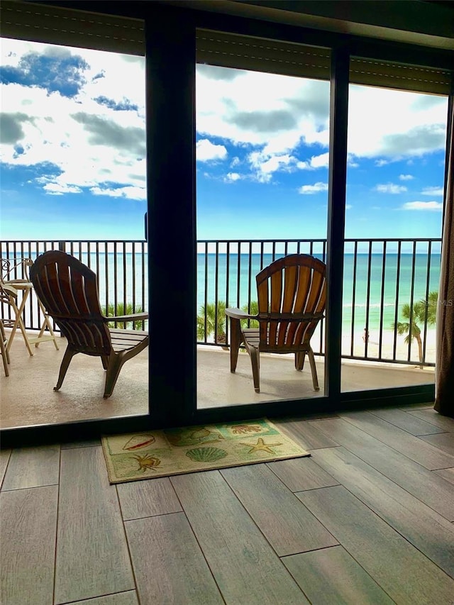 balcony with a beach view and a water view