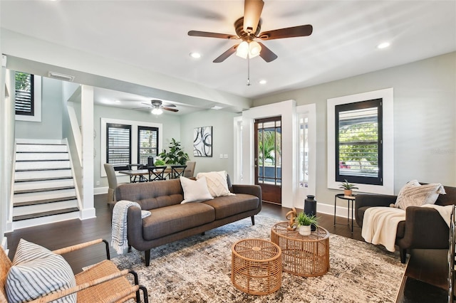 living room featuring ceiling fan and dark hardwood / wood-style flooring