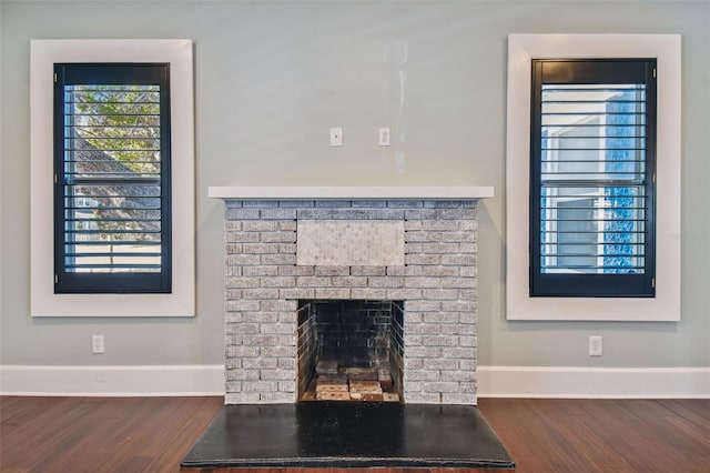 details with hardwood / wood-style flooring and a fireplace