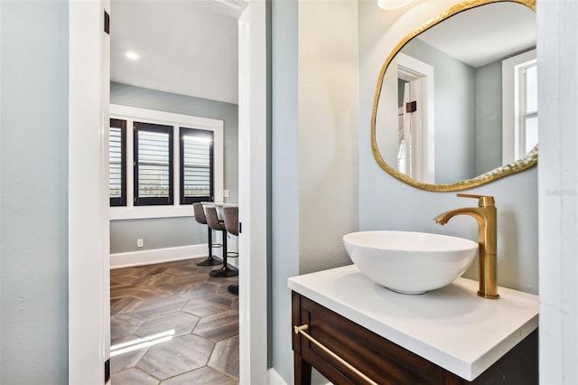 bathroom featuring vanity and parquet flooring