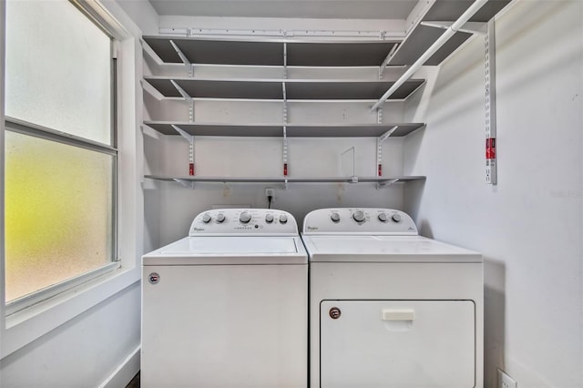 clothes washing area with separate washer and dryer