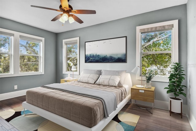 bedroom with ceiling fan and dark hardwood / wood-style floors