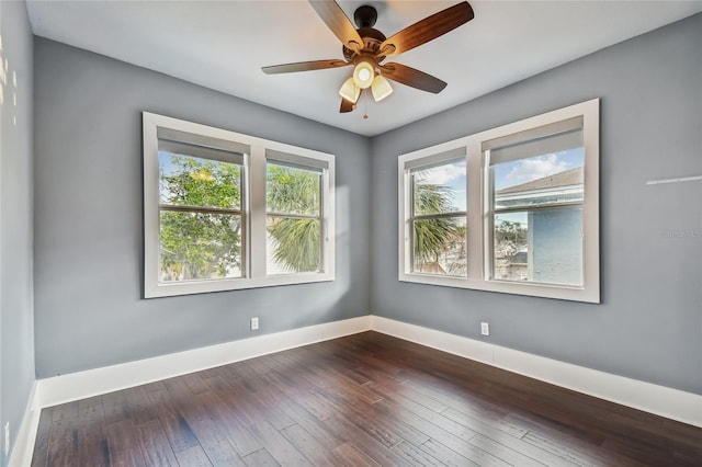 spare room featuring ceiling fan and dark hardwood / wood-style flooring