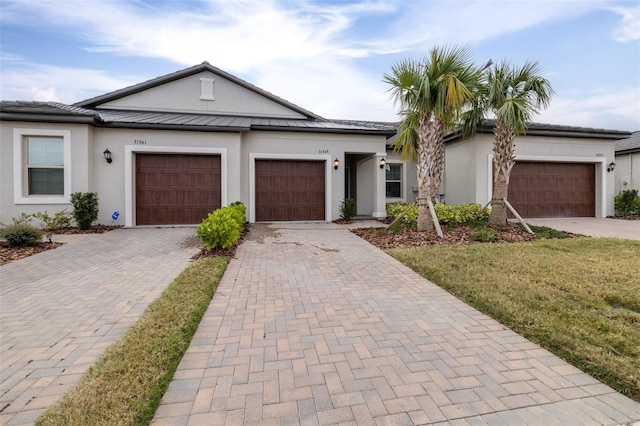 view of front of home featuring a garage and a front lawn