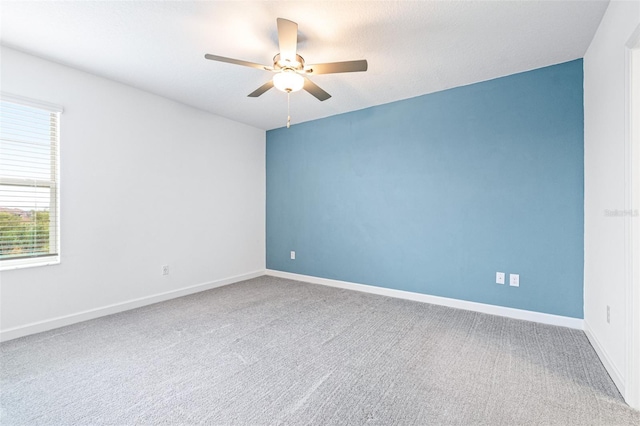 unfurnished room with carpet floors and ceiling fan