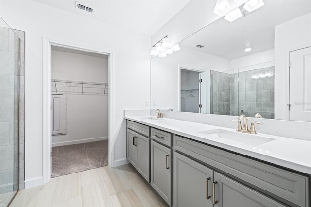 bathroom featuring vanity and a shower with door