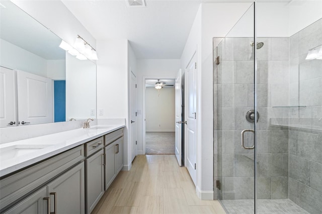 bathroom featuring vanity, ceiling fan, and walk in shower