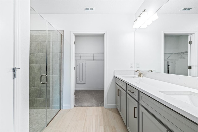 bathroom with vanity and an enclosed shower