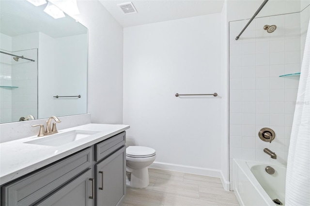 full bathroom with vanity, shower / tub combo, and toilet