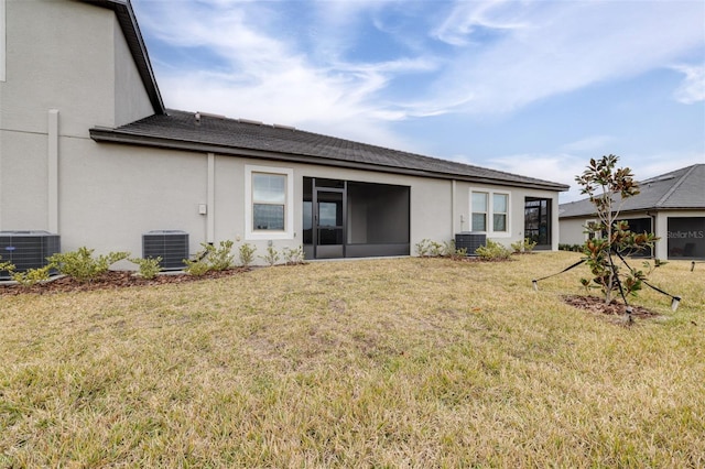 back of house with a yard and central AC