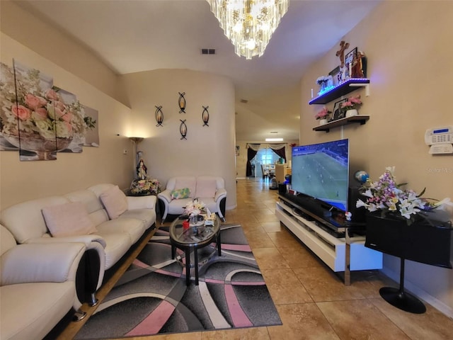 living room featuring a chandelier and light tile patterned flooring