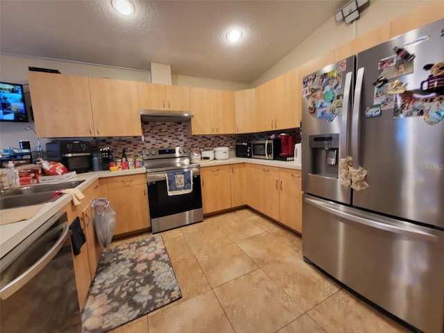 kitchen with light tile patterned floors, sink, appliances with stainless steel finishes, backsplash, and light brown cabinets