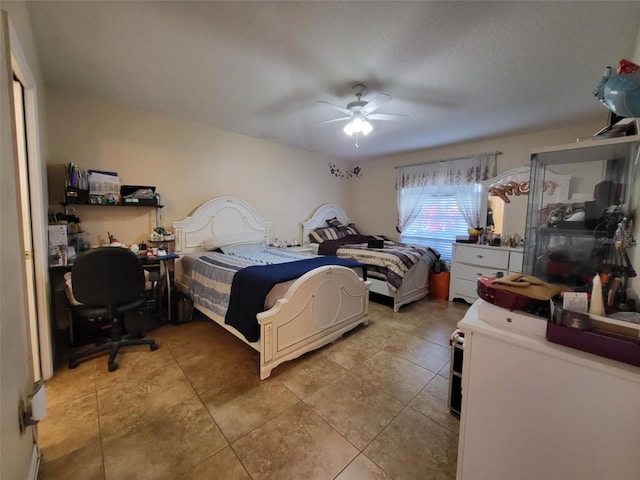 tiled bedroom featuring ceiling fan