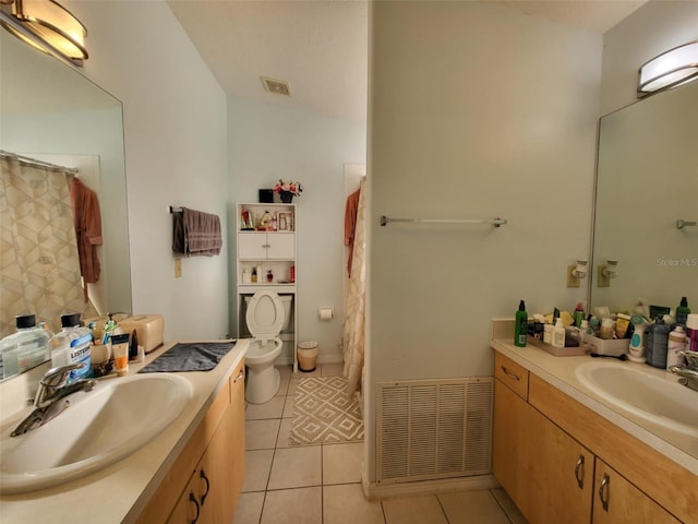 bathroom with tile patterned flooring, vanity, and toilet