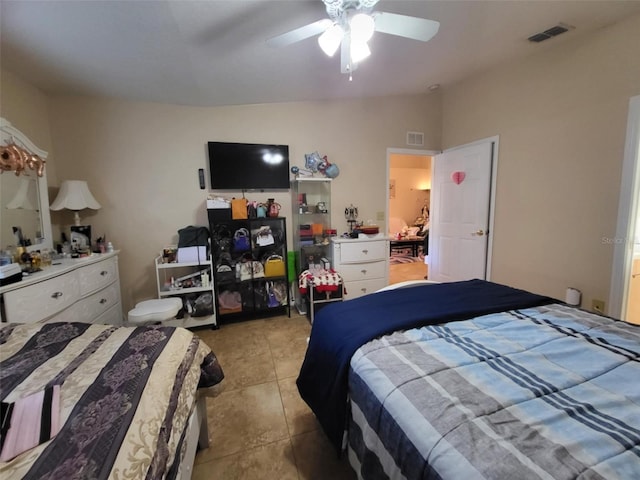 tiled bedroom featuring lofted ceiling and ceiling fan