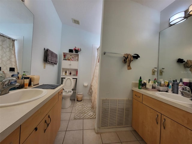 bathroom featuring vanity, tile patterned floors, and toilet