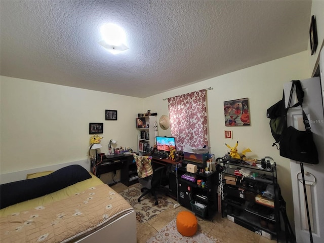 bedroom featuring light tile patterned flooring and a textured ceiling