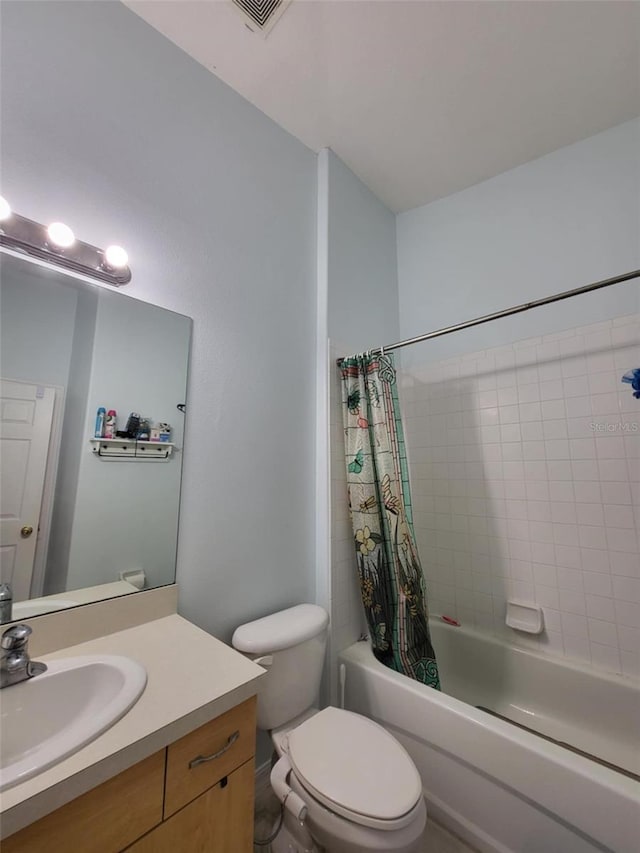 full bathroom featuring vanity, shower / bath combination with curtain, and toilet